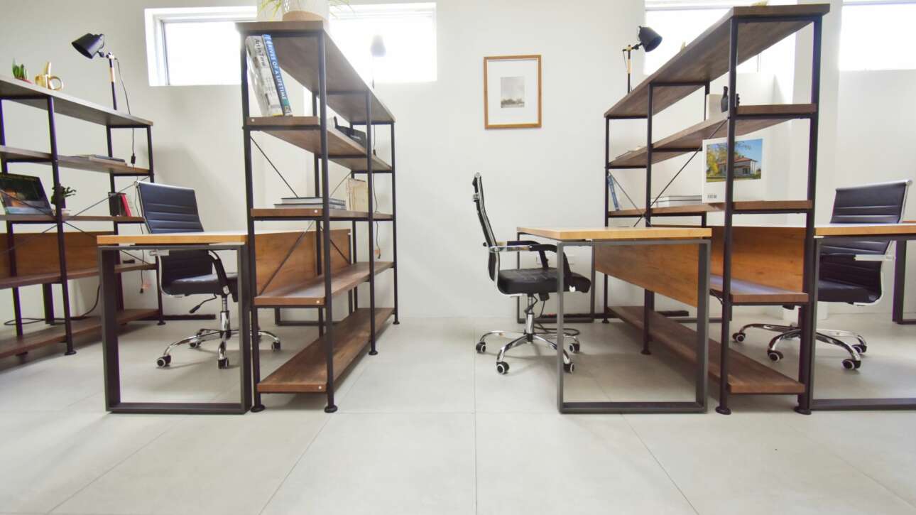 Hotdesks are creatively separated by bookshelves to create privacy without the feeling of seclusion