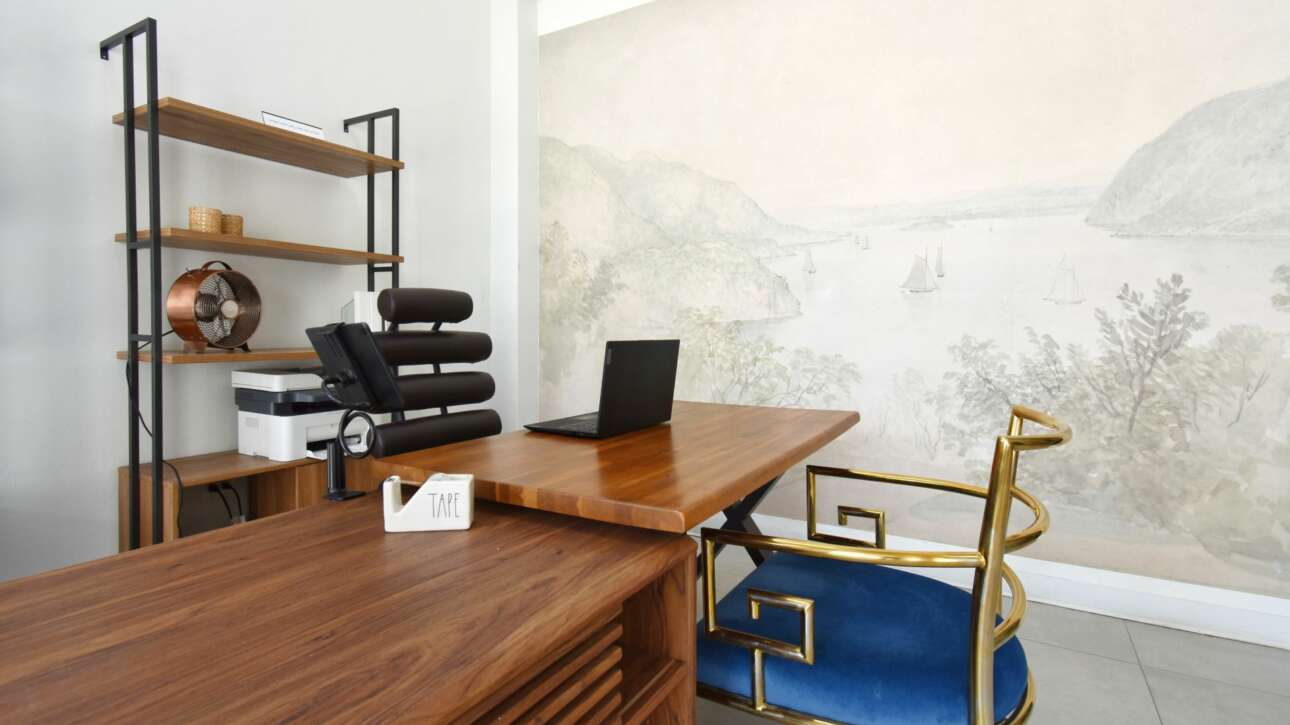 The reception area of the Hub sets the tone for the rest of the space with sculptural seating and a serene mural